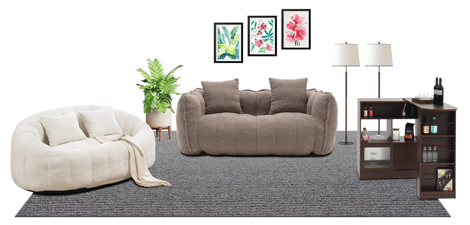 A cozy living room with round sofa, plush couch, greenery, framed art and a bar cabinet